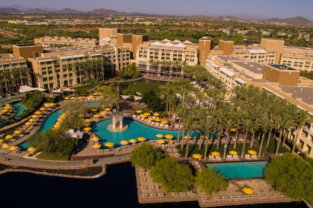 Aerial View of JW Marriot Desert Ridge where the conference will be held with tan colored buildings and a lazy river